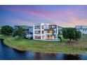 Stunning waterfront home with a modern design, pool, and lush landscaping at 8157 Elion St, Orlando, FL 32827
