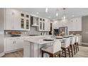Modern kitchen featuring a central island with seating, stainless steel appliances, and white cabinetry at 940 Club Cresswind Dr, Lady Lake, FL 32159