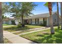 Inviting single-story home with a spacious front yard and mature trees, offering curb appeal at 978 N Jerico Dr, Casselberry, FL 32707