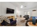 Comfortable living room with ceiling fan, tile floors, and sliding doors to the outdoor area at 978 N Jerico Dr, Casselberry, FL 32707