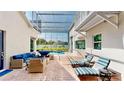 Comfortable outdoor seating and lounge chairs in a screened pool area at 100 Demens St, Oakland, FL 34760