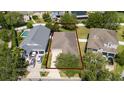 Aerial view of a home with a defined property line, showcasing the surrounding neighborhood and landscaping at 10076 Kimble Field Way, Orlando, FL 32827
