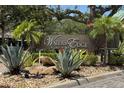 Elegant Waters Edge community sign surrounded by lush landscaping, including palm trees and agave plants at 10076 Kimble Field Way, Orlando, FL 32827
