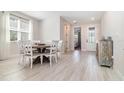 Bright dining room with wood-look floors, lots of natural light, and a decorative cabinet at 1073 River Otter Way, Deland, FL 32720