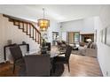 Bright, staged living room featuring a fireplace, chandelier, and staircase at 1085 Island Way, Leesburg, FL 34748
