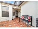 Welcoming entryway featuring a tiled patio with comfortable bench seating and a decorative front door at 109 Lakepointe Cir, Kissimmee, FL 34743