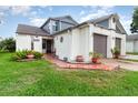 Inviting home exterior showcasing a lush green lawn, tiled entryway, and a well-maintained two-car garage at 109 Lakepointe Cir, Kissimmee, FL 34743