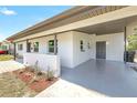 Covered front porch with brick accents, painted concrete floor, and landscaping at 1118 Roberta Ave, Orlando, FL 32825