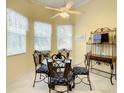 Cozy breakfast nook with a glass table, ornate chairs, and bright natural light from surrounding windows at 118 Ventana Dr, Poinciana, FL 34759