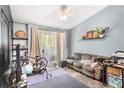 Comfortable living room featuring light blue walls and outdoor access at 1325 Lake Shadow Cir # 12303, Maitland, FL 32751