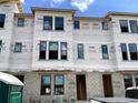 Townhome under construction featuring multiple windows, block foundation, and Typar-branded moisture wrap at 15465 Hamlin Park Drive, Winter Garden, FL 34787