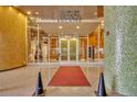 Modern condominium building entrance with glass doors and mosaic columns at 155 S Court Ave # 1909, Orlando, FL 32801
