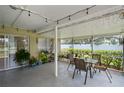 Inviting screened-in patio with dining area and view of the backyard at 1748 Harvest Cv, Winter Park, FL 32792
