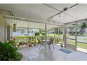 Relaxing screened-in patio with a dining table, chairs, and potted plants for outdoor enjoyment at 1748 Harvest Cv, Winter Park, FL 32792