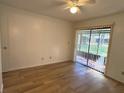 Bright bedroom with wood floors, and sliding door access to the outdoors at 1825 Foxhall Cir # 1825, Kissimmee, FL 34741