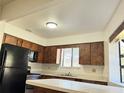 Functional kitchen with a breakfast bar, ample counter space, and black appliances at 1825 Foxhall Cir # 1825, Kissimmee, FL 34741