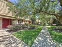 Charming townhouse complex with lush green lawns and mature trees creating a serene atmosphere at 200 Saint Andrews Blvd # 3002, Winter Park, FL 32792