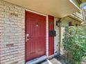 Close-up of the red front door featuring a modern smart lock and matching mailbox at 200 Saint Andrews Blvd # 3002, Winter Park, FL 32792