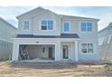 Two story home featuring an open garage, light colored siding and an entry door at 2649 Great Heron Ave, St Cloud, FL 34773
