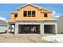Unfinished two-story home featuring a two car garage and an unfinished front yard at 2649 Great Heron Ave, St Cloud, FL 34773