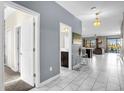 Hallway with tile floors leading to an open-concept living area and a bathroom at 2927 Fable St, Kissimmee, FL 34746