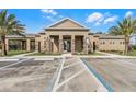 Community building with tan walls, stone columns, and accessible parking spaces in front at 3334 Arch Ave, Ormond Beach, FL 32174