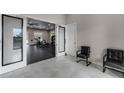 View into the fitness center complete with modern equipment and ample natural light at 3334 Arch Ave, Ormond Beach, FL 32174