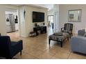Open-concept living room with tile flooring, neutral walls, and comfortable seating arrangement at 340 Haversham Way, Davenport, FL 33897