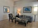 Cozy living room featuring neutral walls, tile flooring, and stylish furniture arrangement at 340 Haversham Way, Davenport, FL 33897