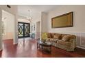 Inviting living room with wainscoting, hardwood floors, and decorative chandelier at 3696 Peacepipe Ct, Clermont, FL 34711