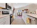 Eat-in kitchen featuring modern appliances, white cabinets, and a dining area with views at 4270 Swan St, Haines City, FL 33844