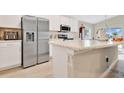 Modern kitchen featuring stainless steel appliances, white cabinets and countertops, and an island at 4270 Swan St, Haines City, FL 33844