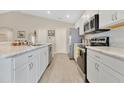 Bright kitchen featuring stainless steel appliances, white cabinetry, and a stylish countertop at 4270 Swan St, Haines City, FL 33844