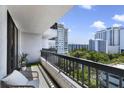 A cozy balcony features a chair, plant and railing with city views at 530 E Central Blvd # 803, Orlando, FL 32801