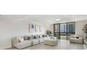 Bright and airy living room with comfortable white couches and balcony access at 530 E Central Blvd # 803, Orlando, FL 32801