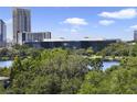 Scenic view of a lake surrounded by lush greenery and modern buildings at 530 E Central Blvd # 803, Orlando, FL 32801