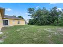 Expansive backyard featuring lush green grass and ample space for outdoor activities and entertaining at 670 Cotulla Dr, Kissimmee, FL 34758