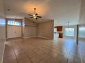 Spacious living area featuring tile flooring and plenty of natural light at 703 Tartan Loop, Lake Wales, FL 33853