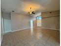 Open concept living room with tile flooring, neutral paint, and a ceiling fan at 703 Tartan Loop, Lake Wales, FL 33853