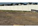 Large leveled backyard surrounded by a pristine white fence, perfect for outdoor activities at 809 River Stone Trl, Sanford, FL 32771