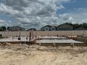 Piping and wooden forms on a foundation, creating a sturdy base for a home, with nearby houses in the background at 809 River Stone Trl, Sanford, FL 32771
