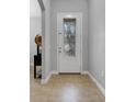 Bright entryway with a decorative glass front door and neutral-toned flooring at 812 Deep Wood Ct, Fruitland Park, FL 34731