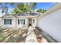 Inviting home exterior with a well-manicured lawn and pathway to the front door at 812 Deep Wood Ct, Fruitland Park, FL 34731