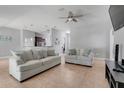 Spacious living room with tile flooring, ceiling fan, and neutral decor at 812 Deep Wood Ct, Fruitland Park, FL 34731