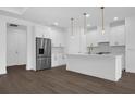 Bright kitchen with white cabinets, stainless steel appliances, and an island, perfect for entertaining at 9265 Eagles Perch Pl, Orlando, FL 32825