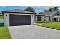Charming single-story home with lush green lawn, stone accents, and a dark-colored two car garage at 934 Jessamy St, Oviedo, FL 32765