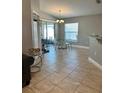 Bright dining area with a modern chandelier and access to the outdoor space at 112 Tulip Ln, Kissimmee, FL 34759