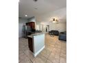 Open concept living room with modern furniture and seamless flow into the kitchen at 112 Tulip Ln, Kissimmee, FL 34759