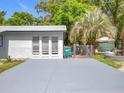 Wide driveway and side of the home, offering ample parking with an enclosed chain-link fence at 1307 Jean Ct, Eustis, FL 32726