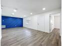 Spacious living room with modern gray flooring, a blue accent wall, and a bright, airy feel at 1307 Jean Ct, Eustis, FL 32726